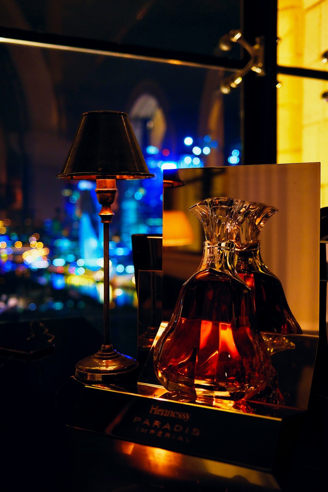 a-table-with-a-lamp-and-a-bottle-on-it-fpf9pbvo-s